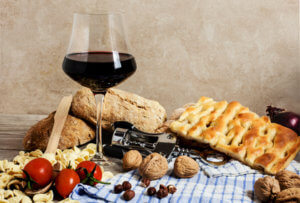 italian food and red wine glass with corkscrew